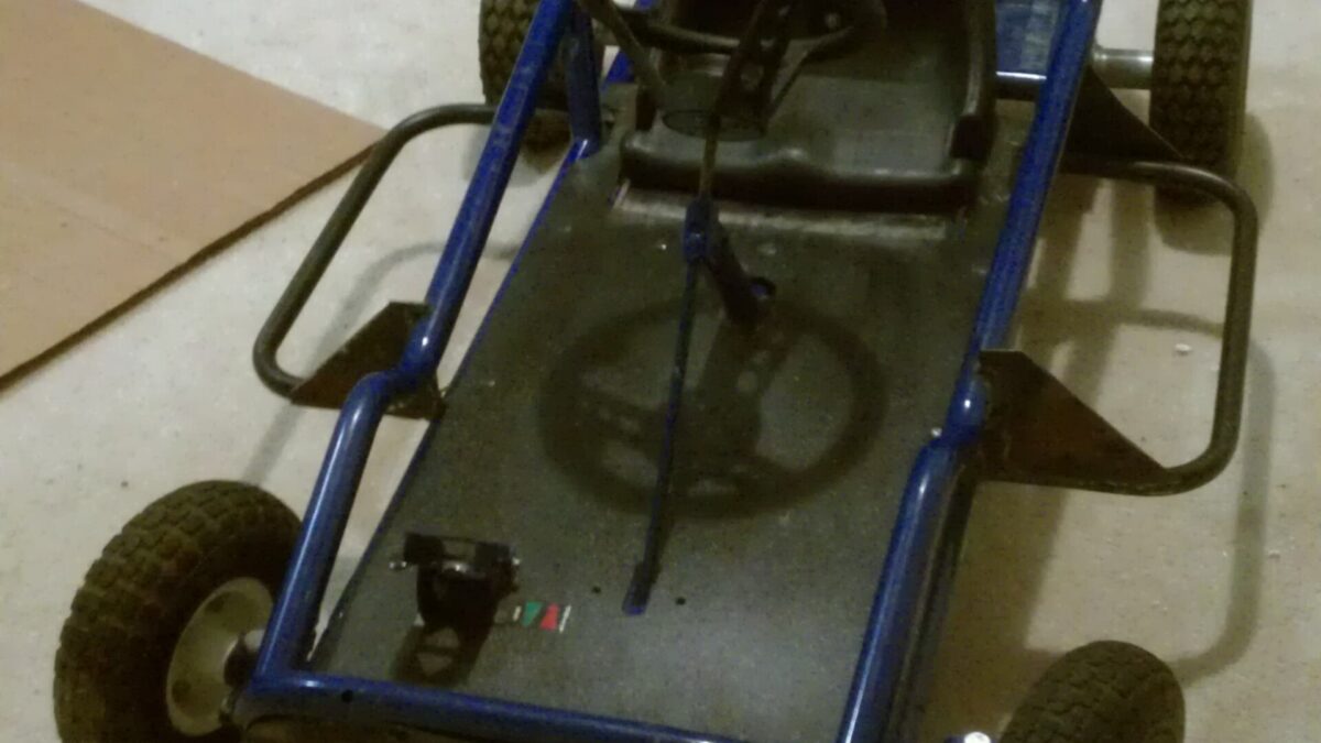 Go-kart frame built from bent blue steel tube with a seat and wheels