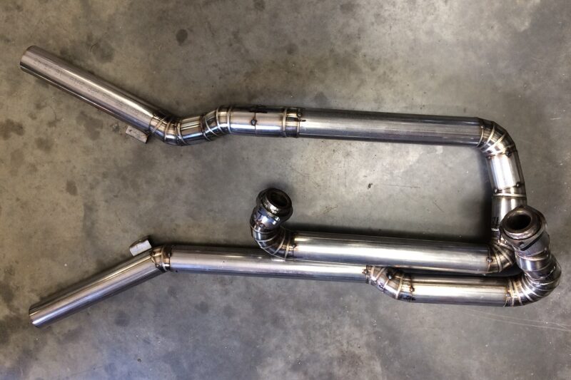 Bent stainless steel exhaust tubes joined with neat TIG weld beads