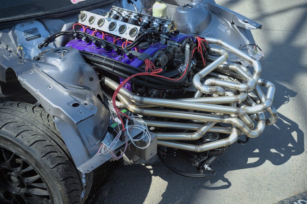 Complex tubular exhaust headers with many tight bends on a V12 engine