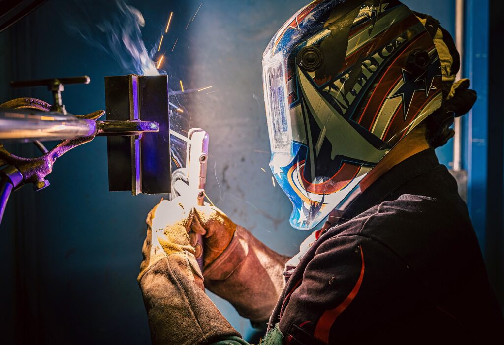 Trainee welding two pieces of metal together